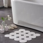 Person enjoying safe shower with non-slip rubber shower mat on floor